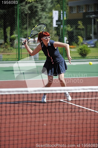 Image of young woman play tennis game outdoor