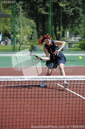 Image of young woman play tennis game outdoor