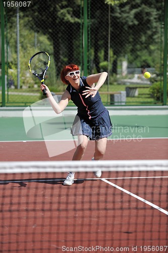 Image of young woman play tennis game outdoor
