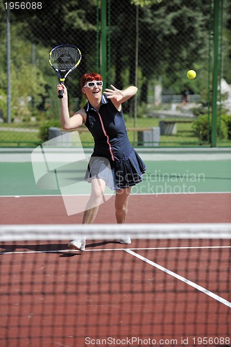 Image of young woman play tennis game outdoor