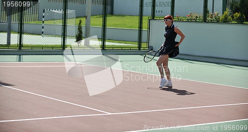 Image of young woman play tennis game outdoor