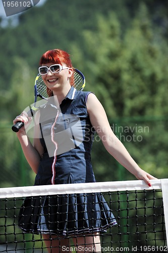 Image of young woman play tennis game outdoor