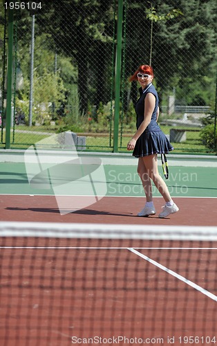Image of young woman play tennis game outdoor