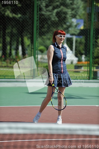 Image of young woman play tennis game outdoor