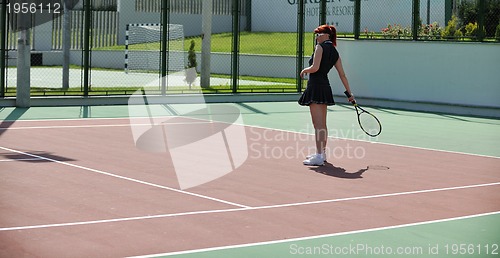 Image of young woman play tennis game outdoor