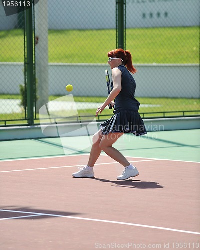 Image of young woman play tennis game outdoor