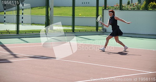 Image of young woman play tennis game outdoor
