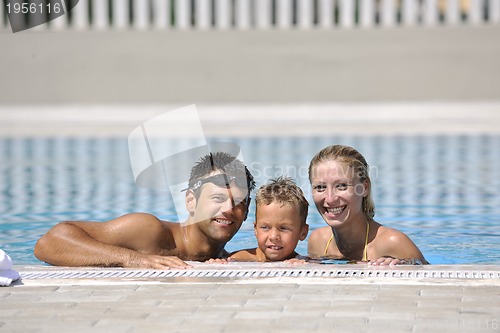 Image of happy young family have fun on swimming pool