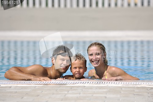 Image of happy young family have fun on swimming pool