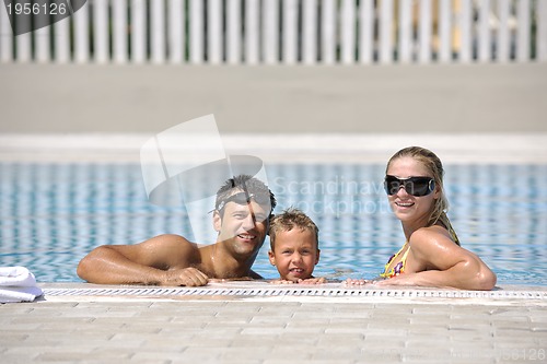 Image of happy young family have fun on swimming pool