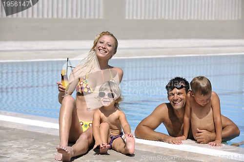 Image of happy young family have fun on swimming pool