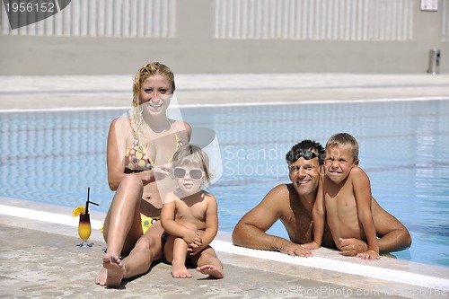 Image of happy young family have fun on swimming pool