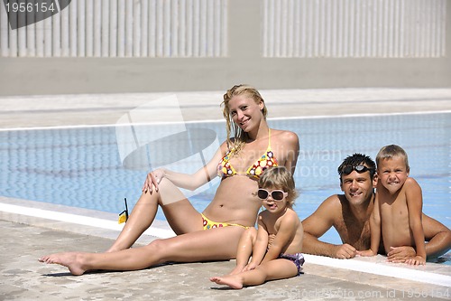 Image of happy young family have fun on swimming pool