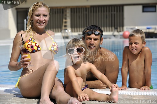 Image of happy young family have fun on swimming pool