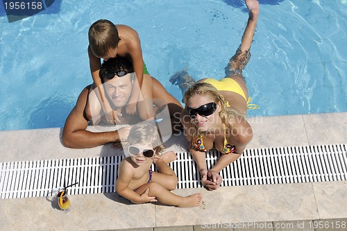 Image of happy young family have fun on swimming pool