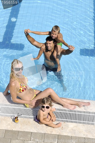 Image of happy young family have fun on swimming pool