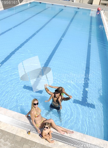 Image of happy young family have fun on swimming pool