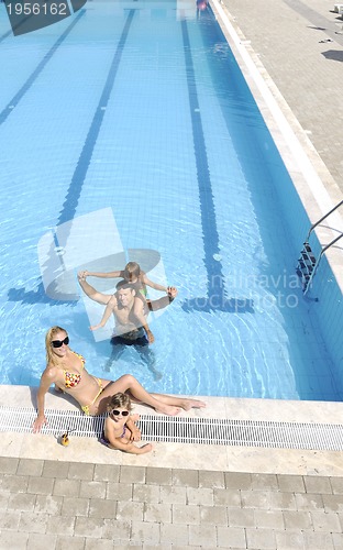 Image of happy young family have fun on swimming pool