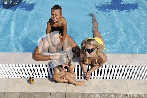 Image of happy young family have fun on swimming pool
