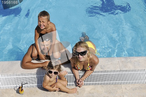 Image of happy young family have fun on swimming pool
