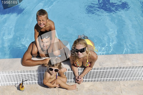 Image of happy young family have fun on swimming pool