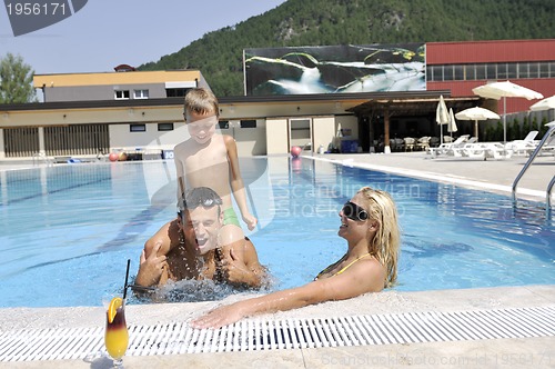 Image of happy young family have fun on swimming pool