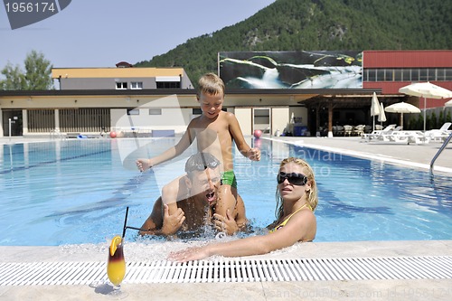 Image of happy young family have fun on swimming pool