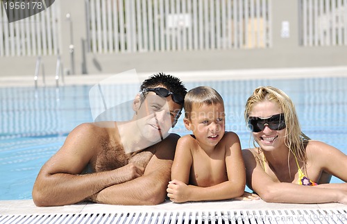Image of happy young family have fun on swimming pool