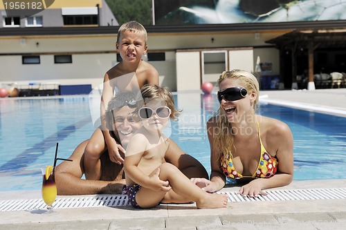Image of happy young family have fun on swimming pool