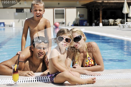 Image of happy young family have fun on swimming pool