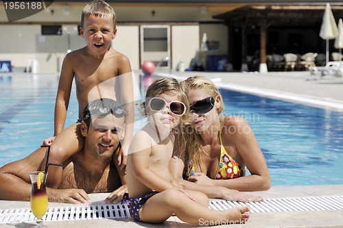Image of happy young family have fun on swimming pool