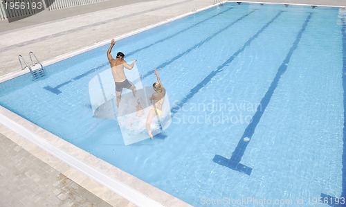 Image of happy young family have fun on swimming pool
