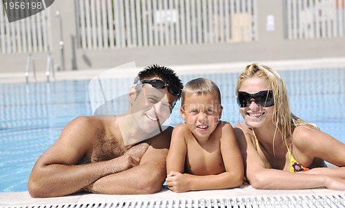 Image of happy young family have fun on swimming pool