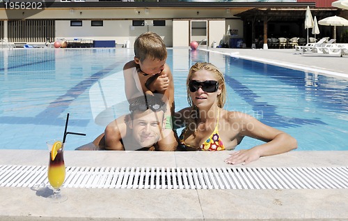 Image of happy young family have fun on swimming pool