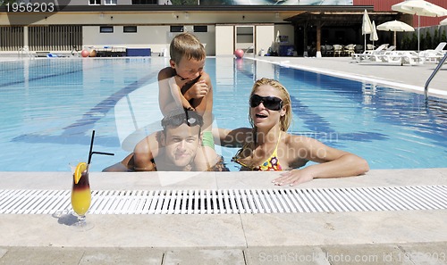 Image of happy young family have fun on swimming pool