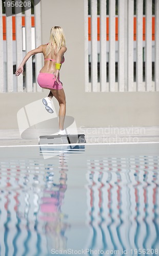 Image of woman fitness exercise at poolside