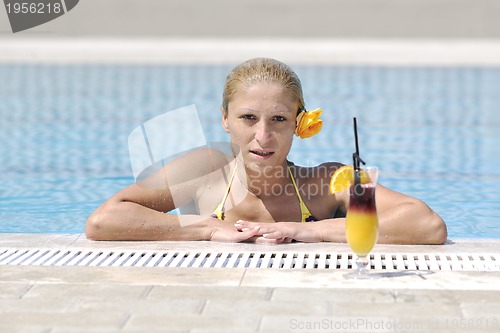 Image of beautiful woman relax on swimming pool