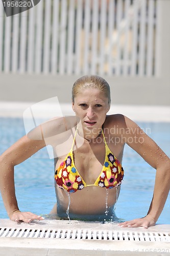 Image of beautiful woman relax on swimming pool