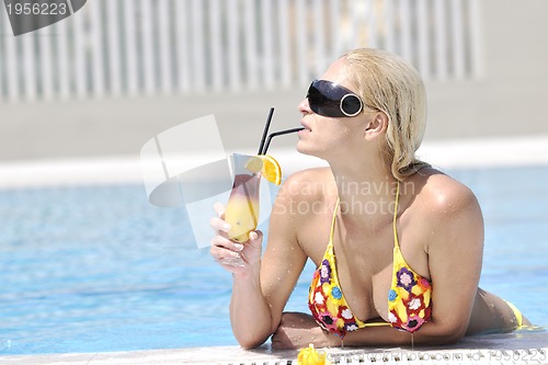Image of beautiful woman relax on swimming pool