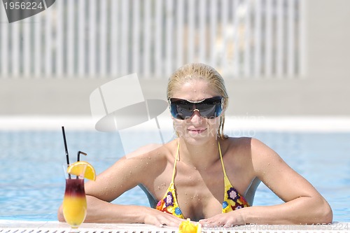 Image of beautiful woman relax on swimming pool