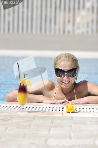 Image of beautiful woman relax on swimming pool