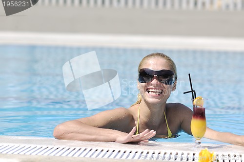 Image of beautiful woman relax on swimming pool