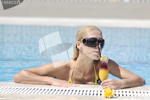 Image of beautiful woman relax on swimming pool