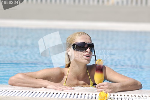 Image of beautiful woman relax on swimming pool