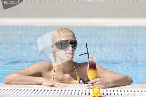 Image of beautiful woman relax on swimming pool