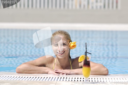 Image of beautiful woman relax on swimming pool