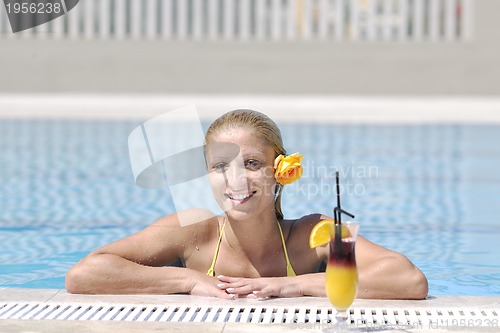 Image of beautiful woman relax on swimming pool