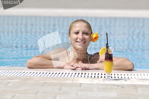 Image of beautiful woman relax on swimming pool