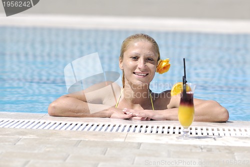 Image of beautiful woman relax on swimming pool