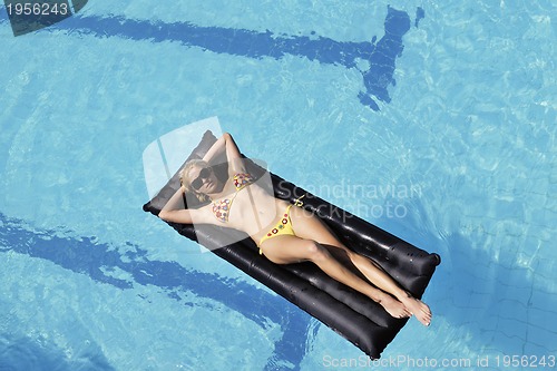 Image of beautiful woman relax on swimming pool